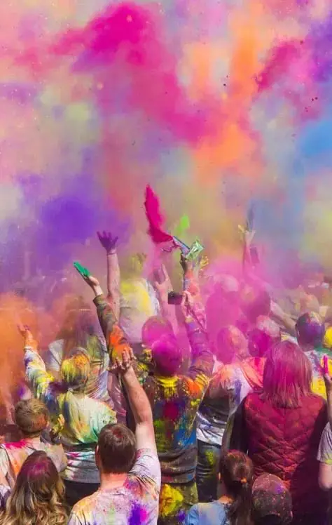 Crowd throwing colour at a Holi celebration